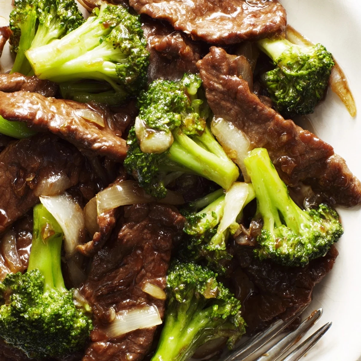 Delicious Quick Beef and Broccoli Stir-Fry served over a bed of steaming rice.