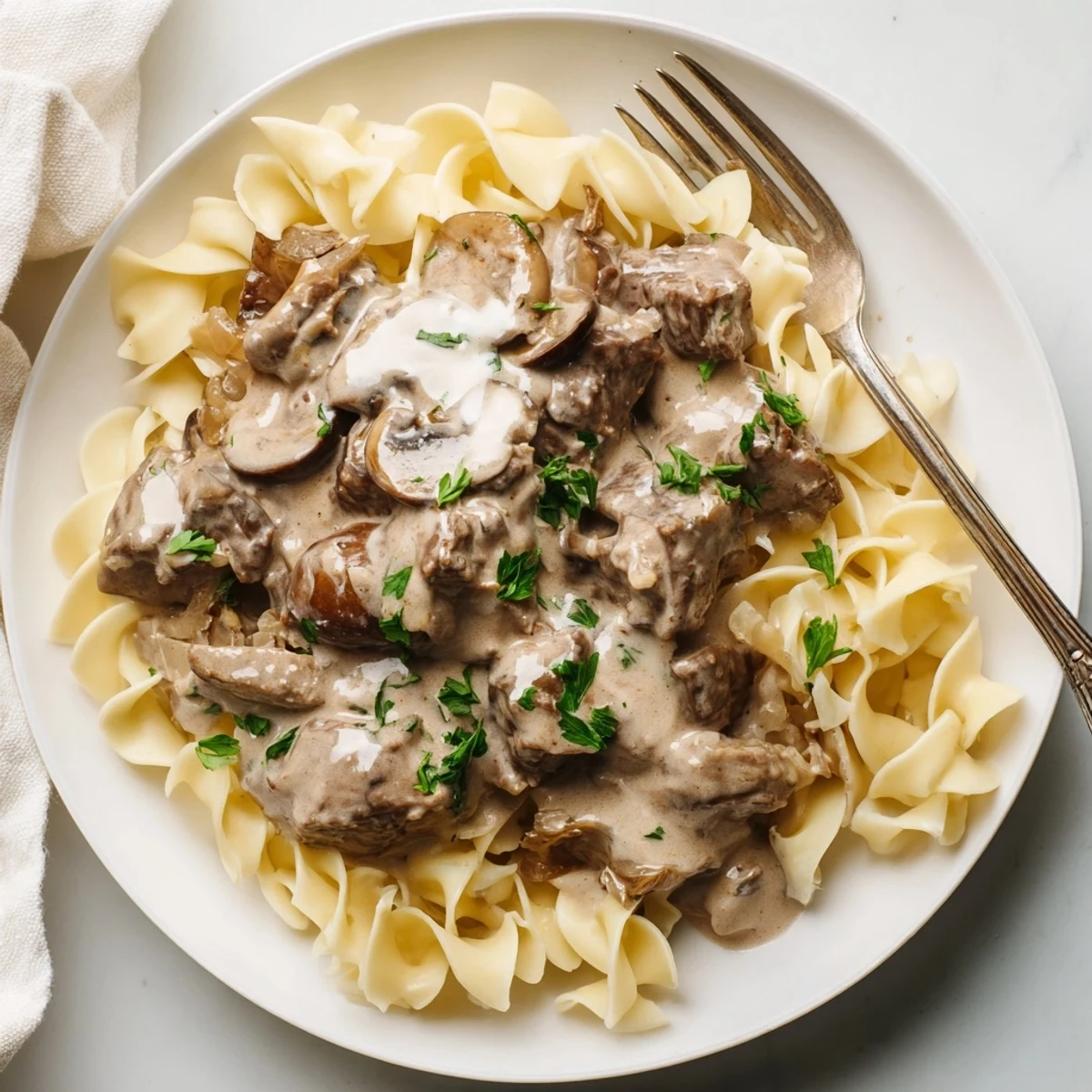 Delicious slow cooker beef stroganoff blending savory spices with rich sour cream sauce.