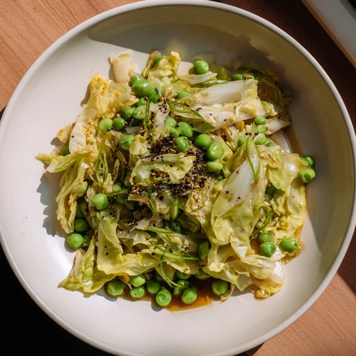 A delicious bowl of Cabbage Stir-Fry bursting with flavor, ready to serve with a garnish of scallions.