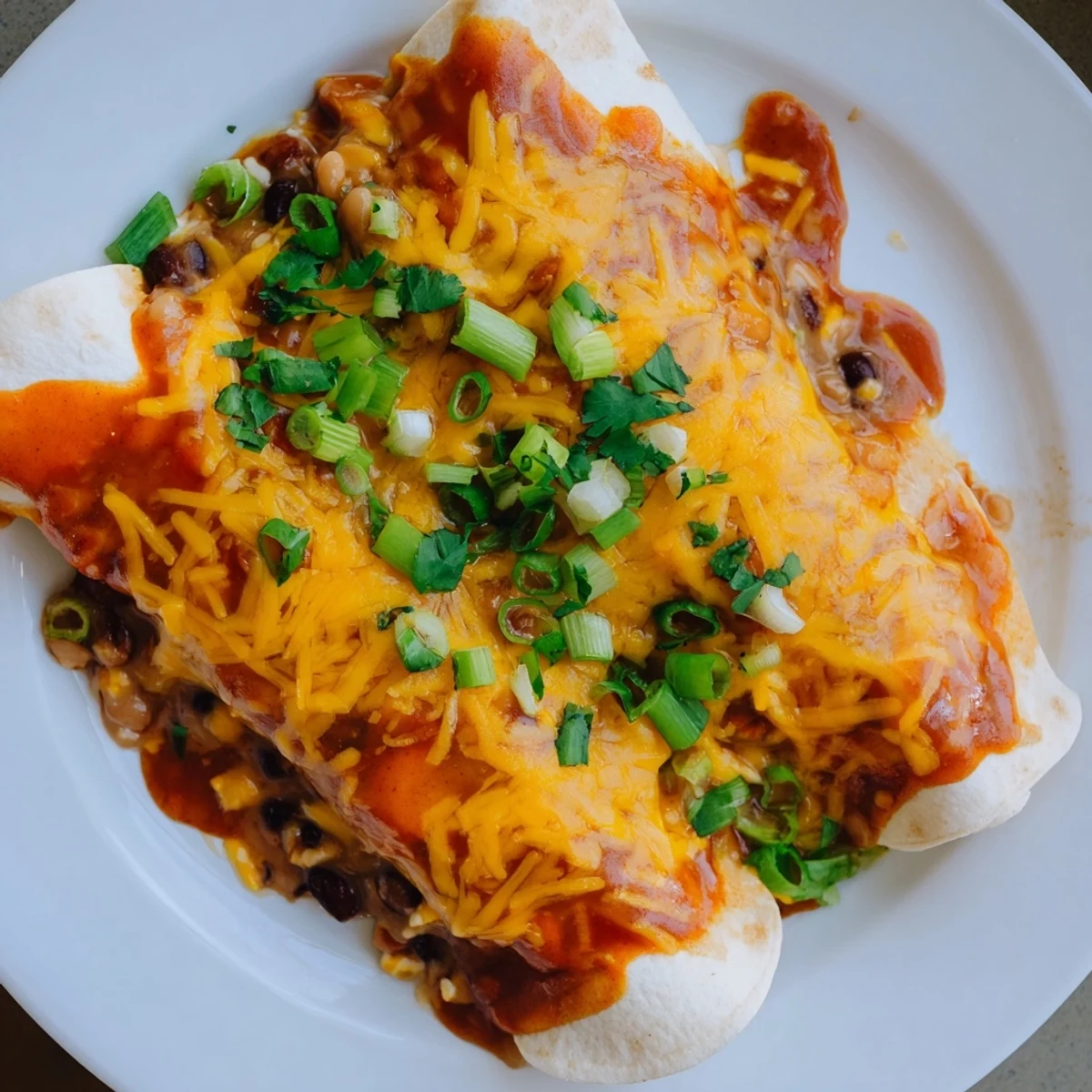 Steaming Cheesy Bean Enchiladas fresh from the oven, with bubbly cheese and savory aroma filling the air.
