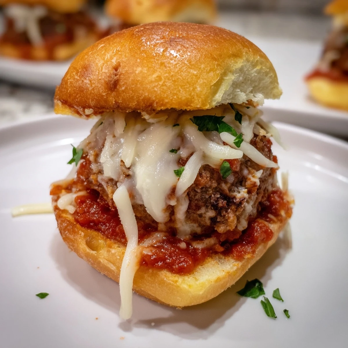 Delectable close-up of cheesy Easy Christmas Meatball Sliders, baked to perfection and ready to serve warm.