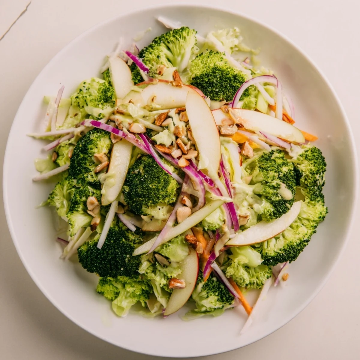 This Broccoli and Apple Hot Girl Salad shows fresh ingredients tossed in a zesty, homemade dressing.