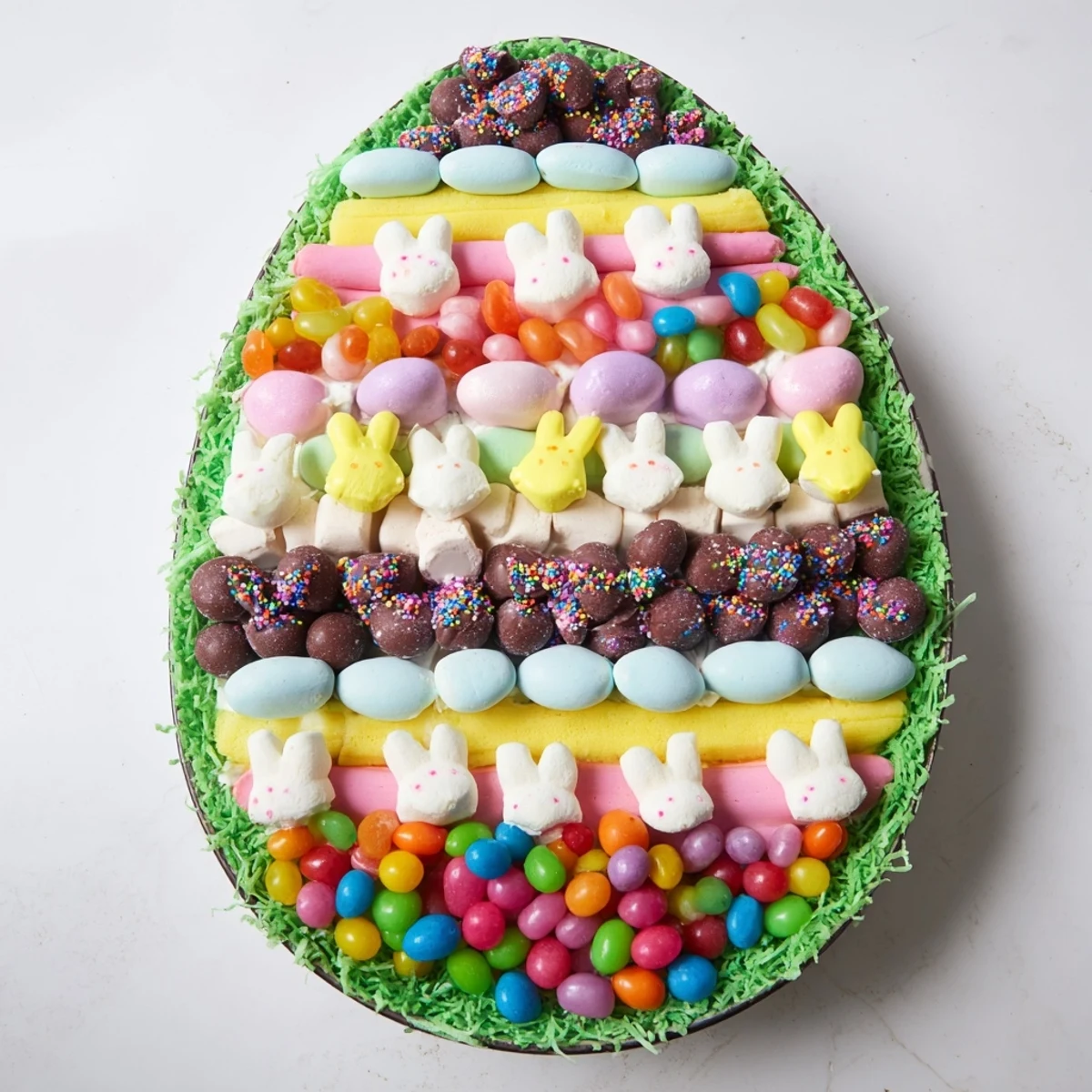 An inviting Egg-Shaped Candy Platter with an array of sweets, including marshmallow chicks, ready for serving.
