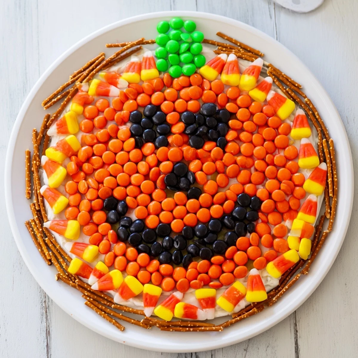 A vibrant Jack-o-Lantern candy board filled with colorful treats, perfect for Halloween celebrations.