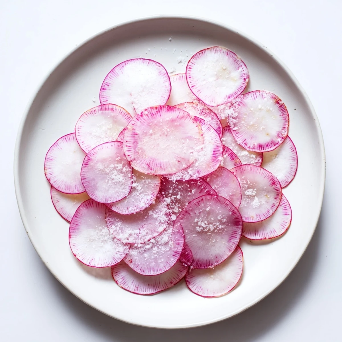 Freshly sliced radishes sprinkled with flaky sea salt, a vibrant and simple appetizer idea.