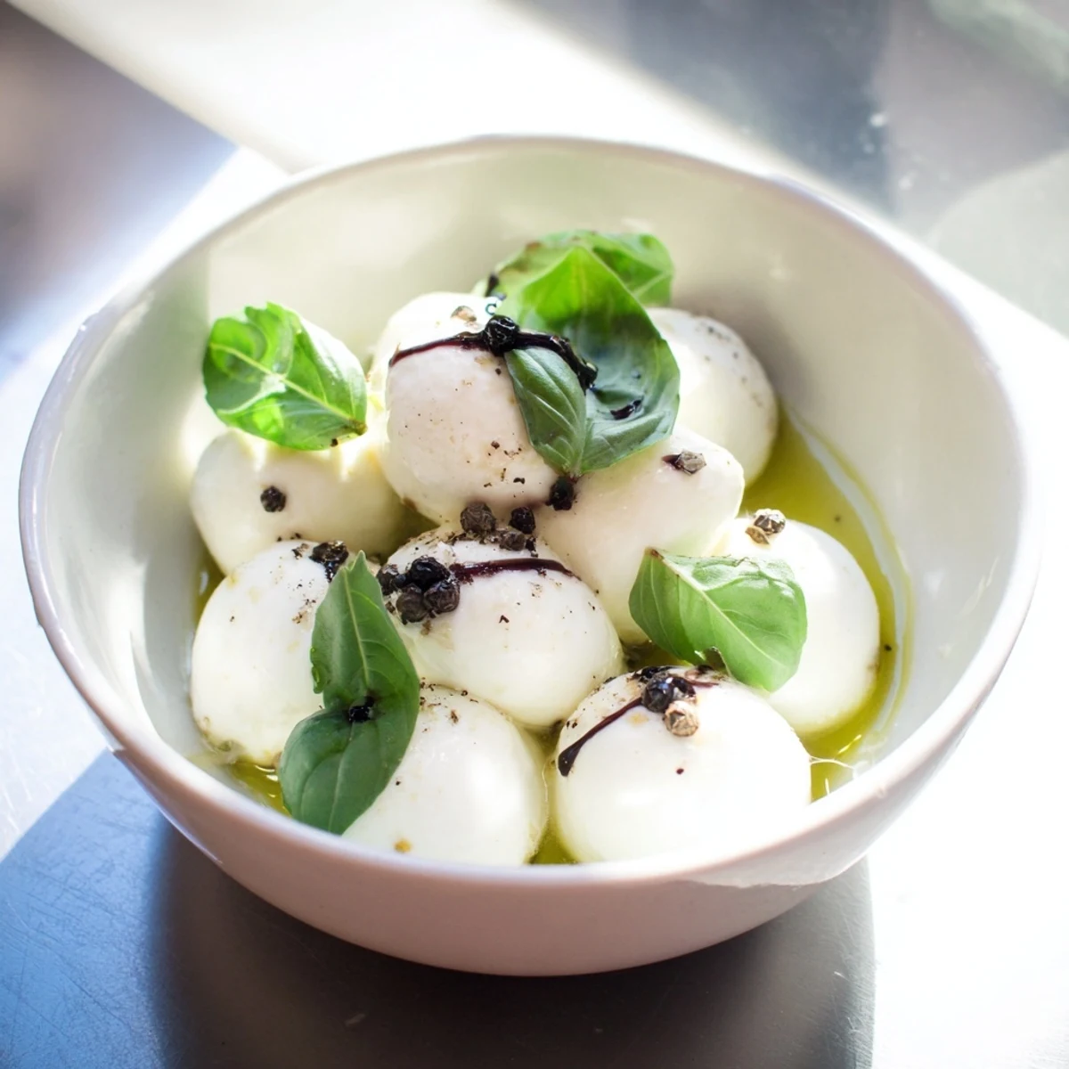 Creamy mozzarella pearls in a bowl, a simple Italian appetizer, ready to serve and enjoy.