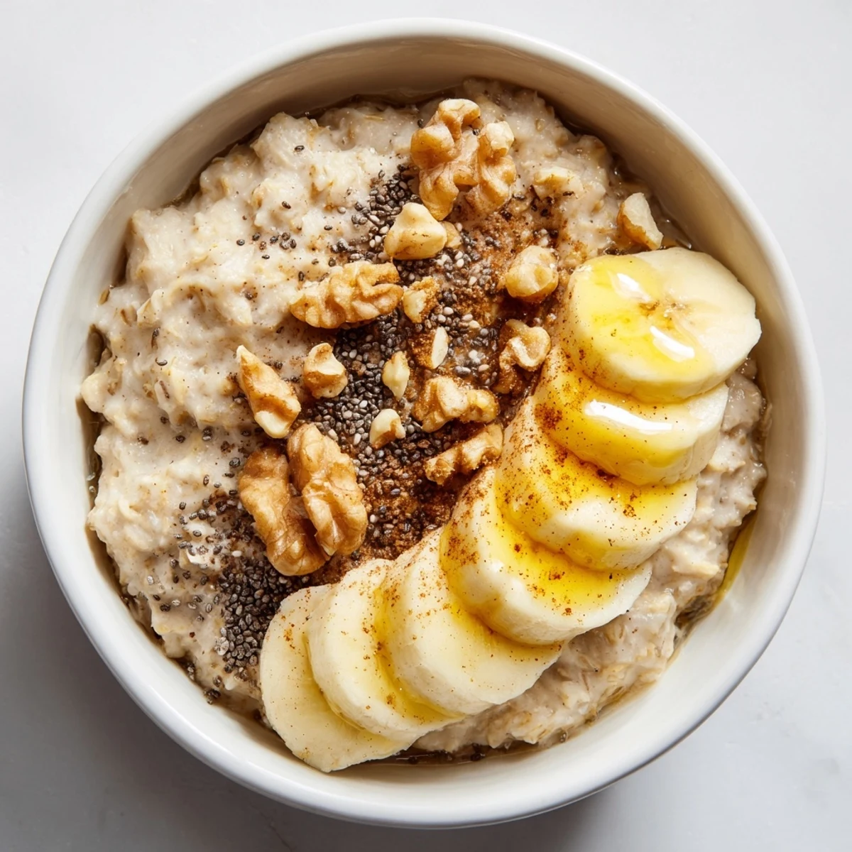 A close-up of a delightful Microwave Banana Oats bowl, topped with fresh banana and nuts, ready to eat.