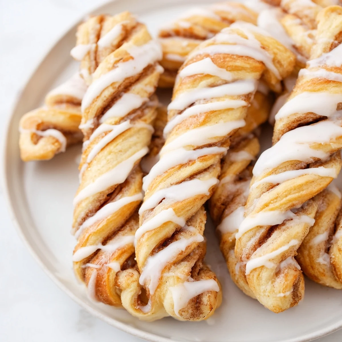 Air-Fryer Cinnamon Roll Twists glistening with sweet glaze, perfect for a quick breakfast or snack.