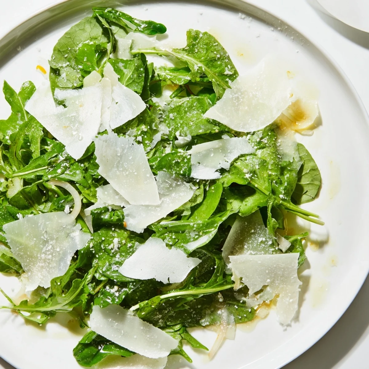This flavorful arugula salad features tossed greens and a vibrant lemon dressing, perfect for a light lunch.