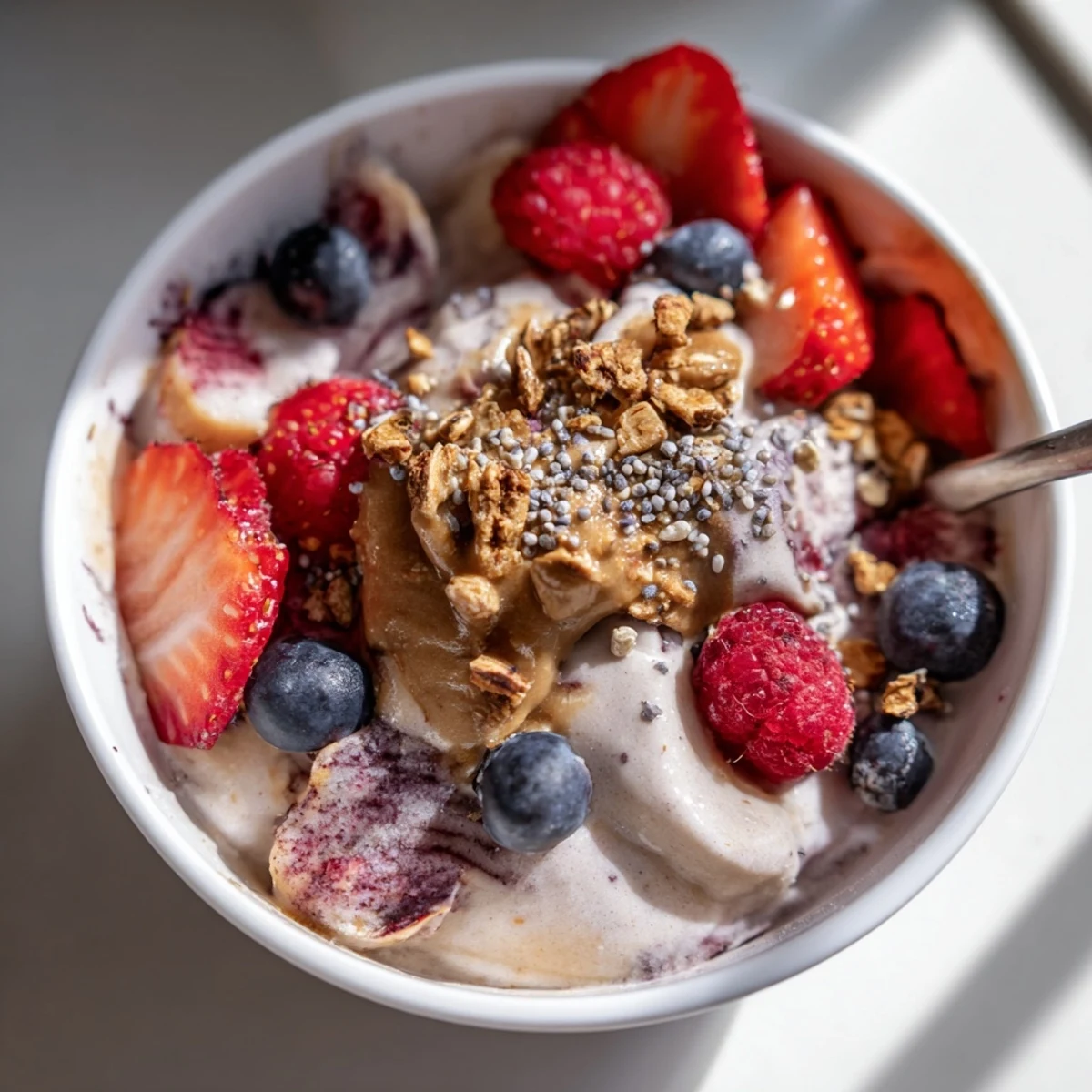 Swirled, creamy protein ice cream bowls featuring frozen banana, promising a delicious, healthy treat.