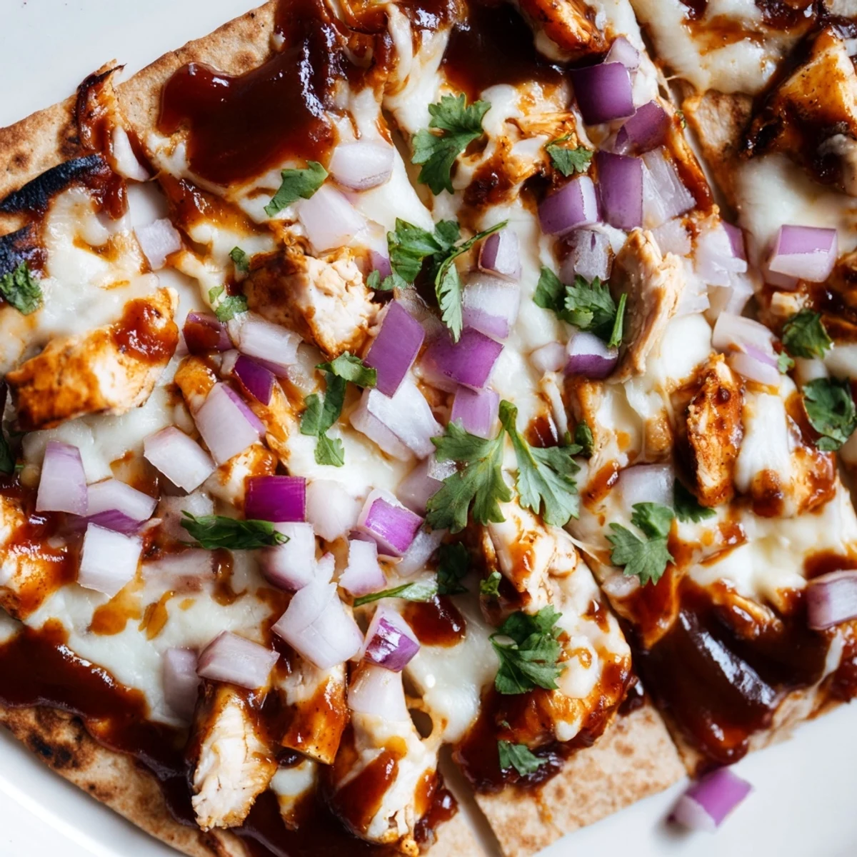 Golden-brown BBQ Chicken Flatbread fresh from the oven, featuring a glossy BBQ sauce glaze and bubbling cheese, perfect for a quick weeknight dinner.