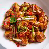 Golden-brown Vietnamese Caramel Chicken glistening, served atop fluffy rice for a delicious main.