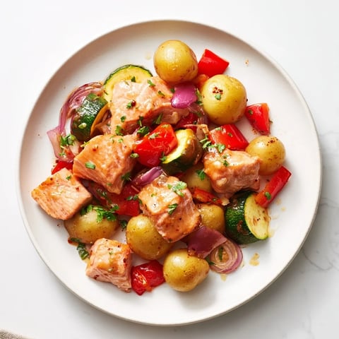 Golden potatoes and flaky salmon pieces sizzle in this delicious Salmon & Potato Skillet recipe.