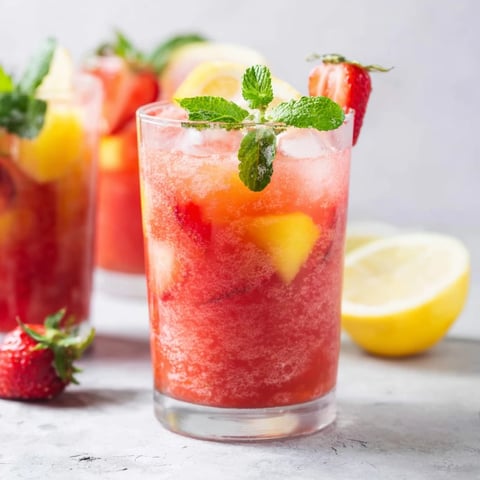 Refreshing close-up of vibrant pink strawberry DIY fruit refresher drinks, perfect for a hot day.