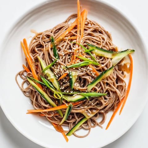 Chilled Noodle Lunch Cups filled with colorful veggies and a savory sesame sauce, perfect for meal prep.