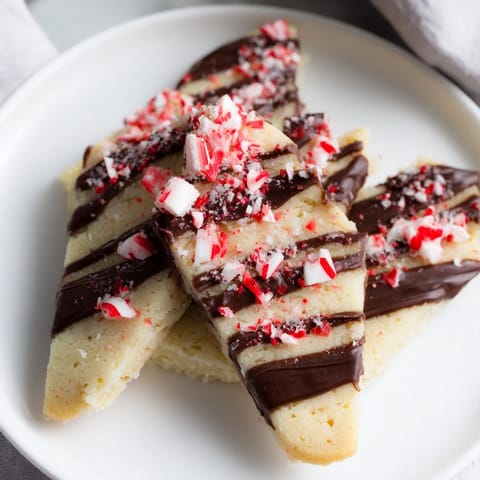 Buttery chocolate peppermint shortbread wedges, perfect for sharing, offer a delightful holiday dessert.
