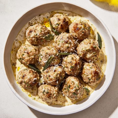 Creamy pumpkin sage sauce coats juicy turkey meatballs, a comforting, delicious meal idea.