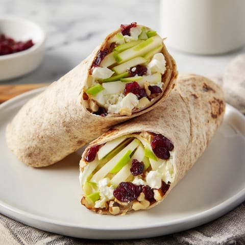 Freshly assembled Cranberry Goat Cheese & Walnut Holiday Wrap, with bright cranberries and walnuts peeking out.