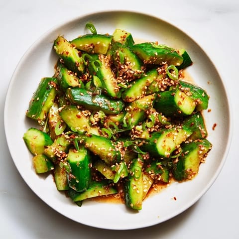 Vibrant Cucumber Shaker salad featuring crispy cucumbers coated in umami-rich rice vinegar dressing.