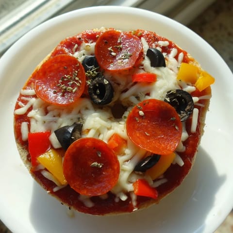 Freshly baked mini bagel pizzas feature melted mozzarella and optional pepperoni toppings.