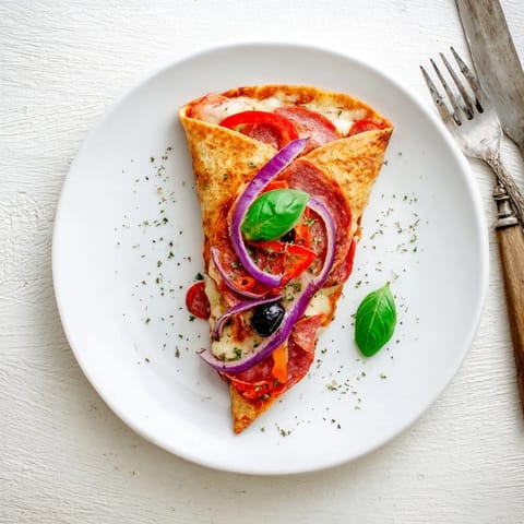 Two crispy, triangular tortilla pizza wraps served hot on a plate, topped with fresh basil and sliced olives.