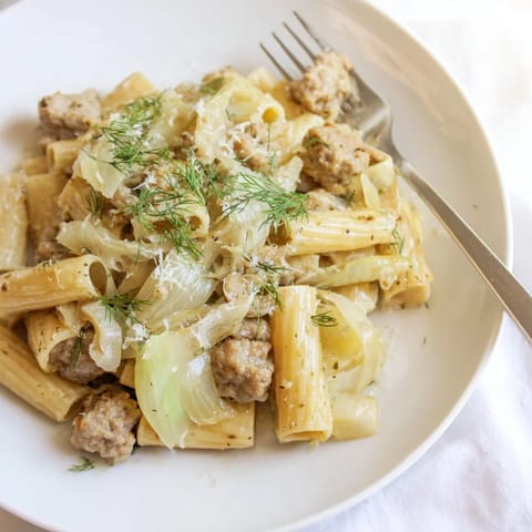 Savory Italian sausage and tender fennel slices tossed through al dente pasta in a light, aromatic white wine sauce.