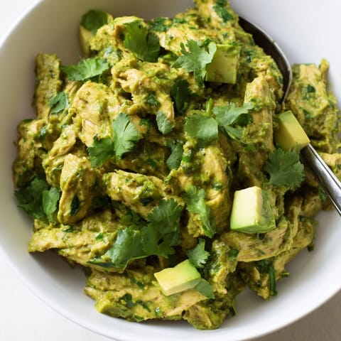 Bright, charred tomatillo and pepper salsa envelops juicy chicken thighs in this hearty, gluten-free Mexican stew, served steaming in a rustic bowl.