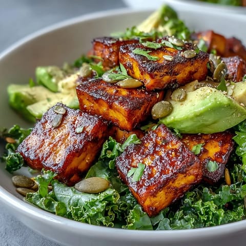 Protein-packed tofu breakfast bowl with golden turmeric tofu, sautéed kale, and creamy avocado slices for a vibrant vegan start.  