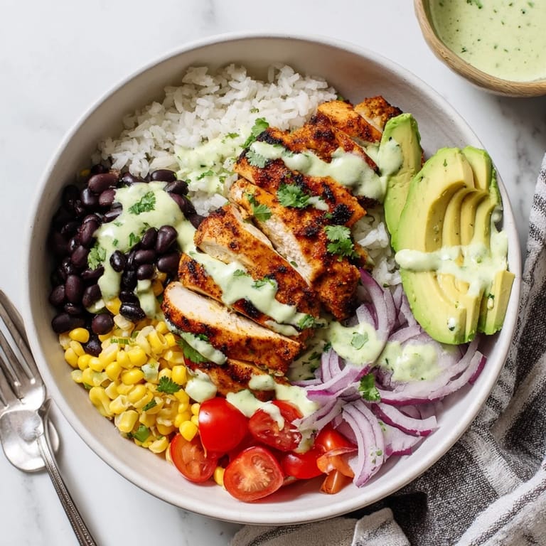 Flavorful Zesty Lime Cilantro Chicken Bowls drizzled with tangy dressing in a hearty serving.  