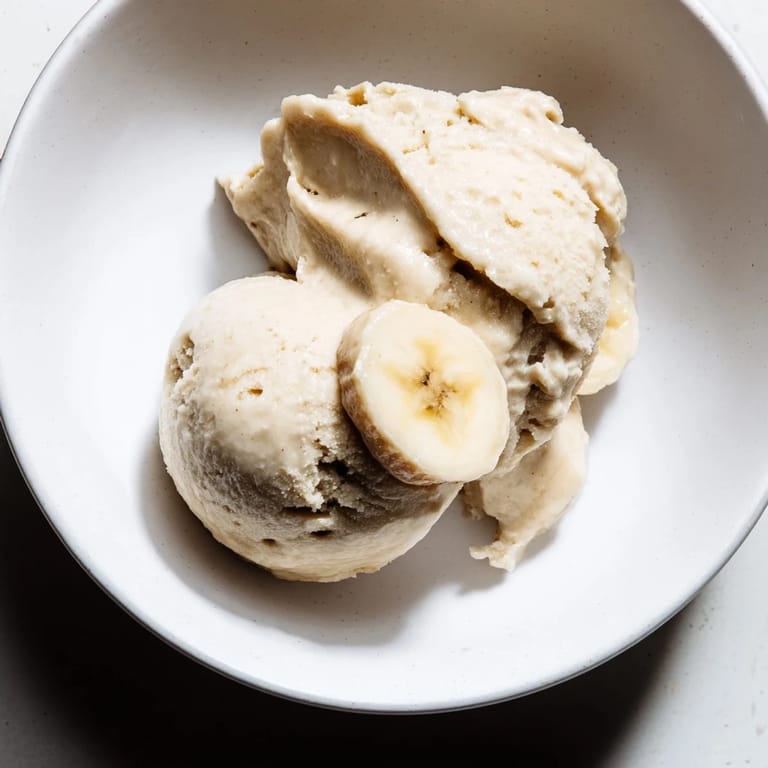 Smooth and sweet 2-Ingredient Banana Ice Cream, a healthy dessert option with frozen banana and milk.