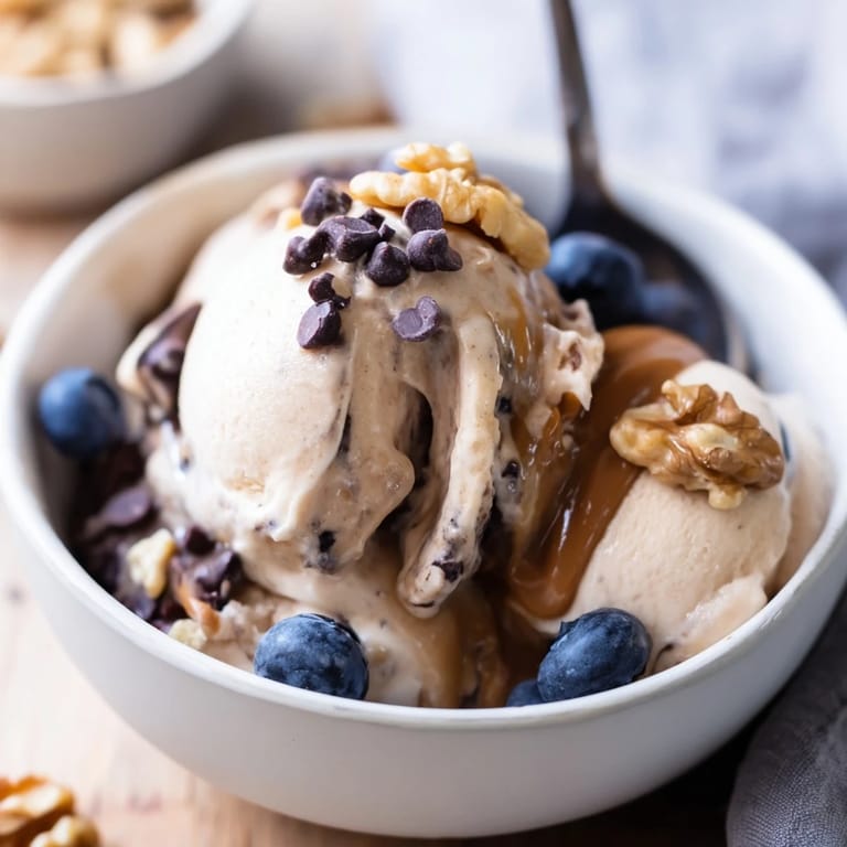 A luscious Protein Ice Cream Bowl topped with fresh berries, ideal as a post-workout dessert.