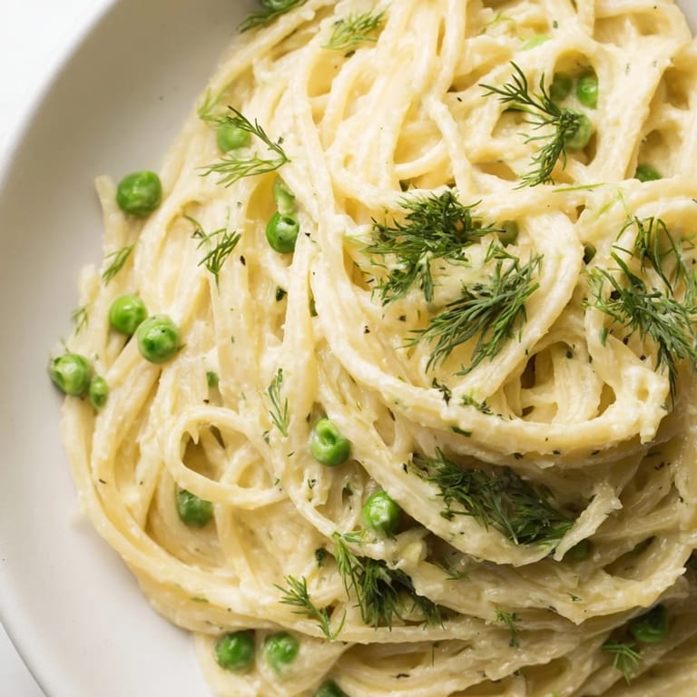 Fresh Creamy Dill Pasta, served with peas, offers a vibrant, aromatic veggie-packed main dish.