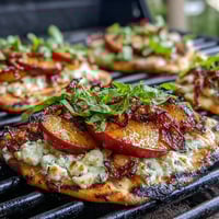 Grilled flatbread topped with sweet peaches, creamy Brie, and smoky BBQ sauce for a summer appetizer.  