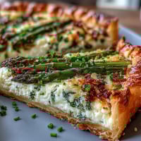 Asparagus Ricotta Tart with lemon zest and Parmesan on a golden puff pastry crust, perfect for spring brunch or light lunch.